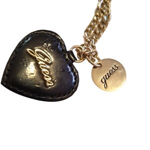 Guess charm black and gold tone